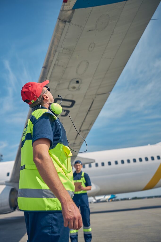 Engineers conducting a visual inspection of an airliner